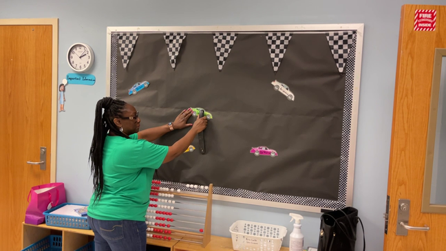  Teacher preparing classroom for school